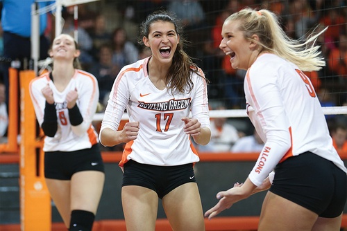 #17 on the Volleyball team cheers alongside her teammates