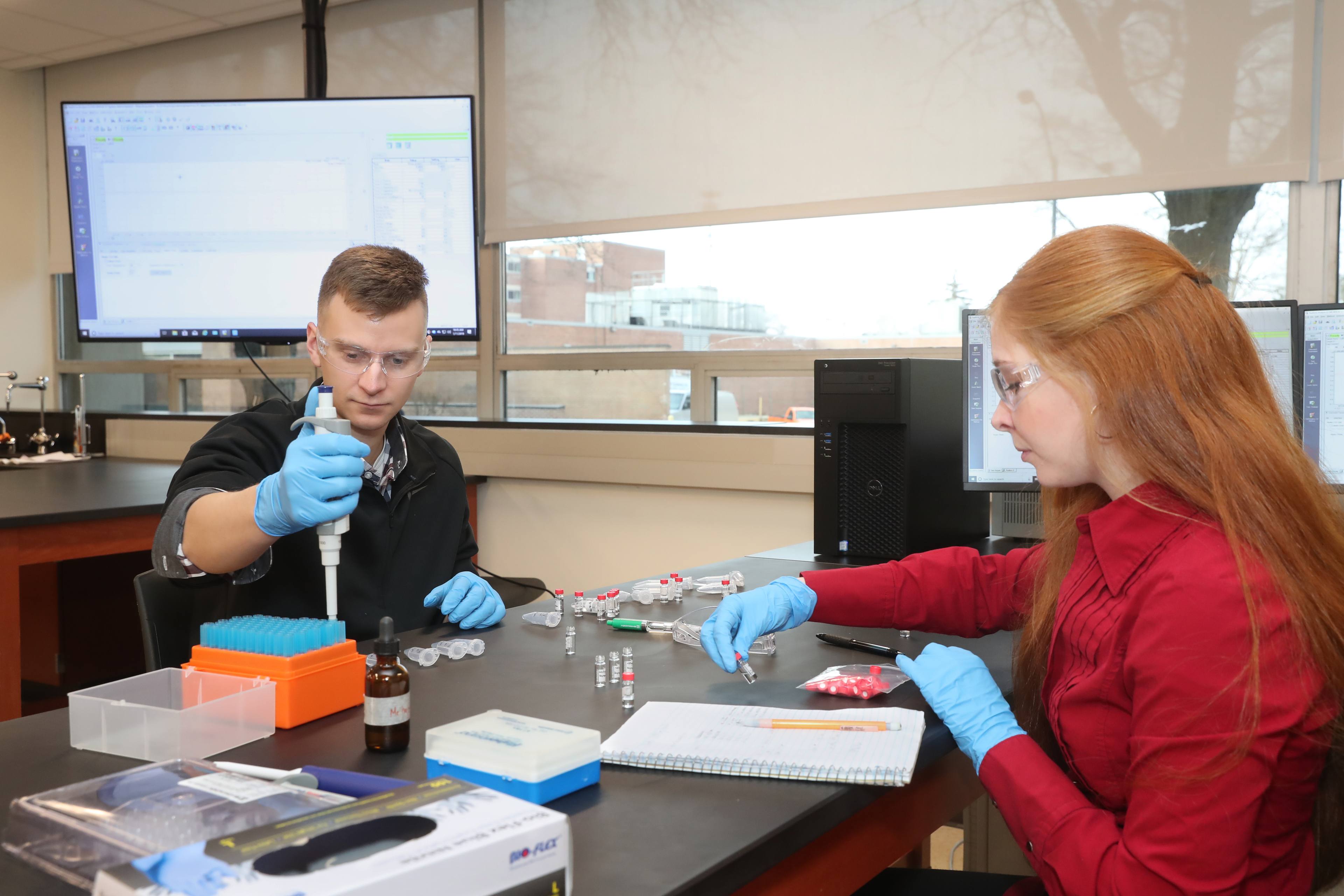 Two students working in a lab.