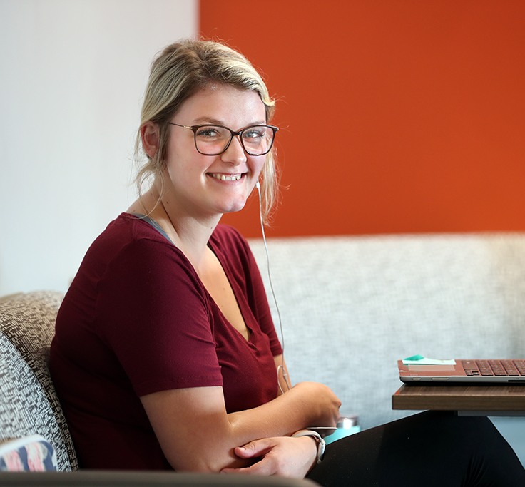 A female applied demographics student at BGSU sits in front of her computer and studies.