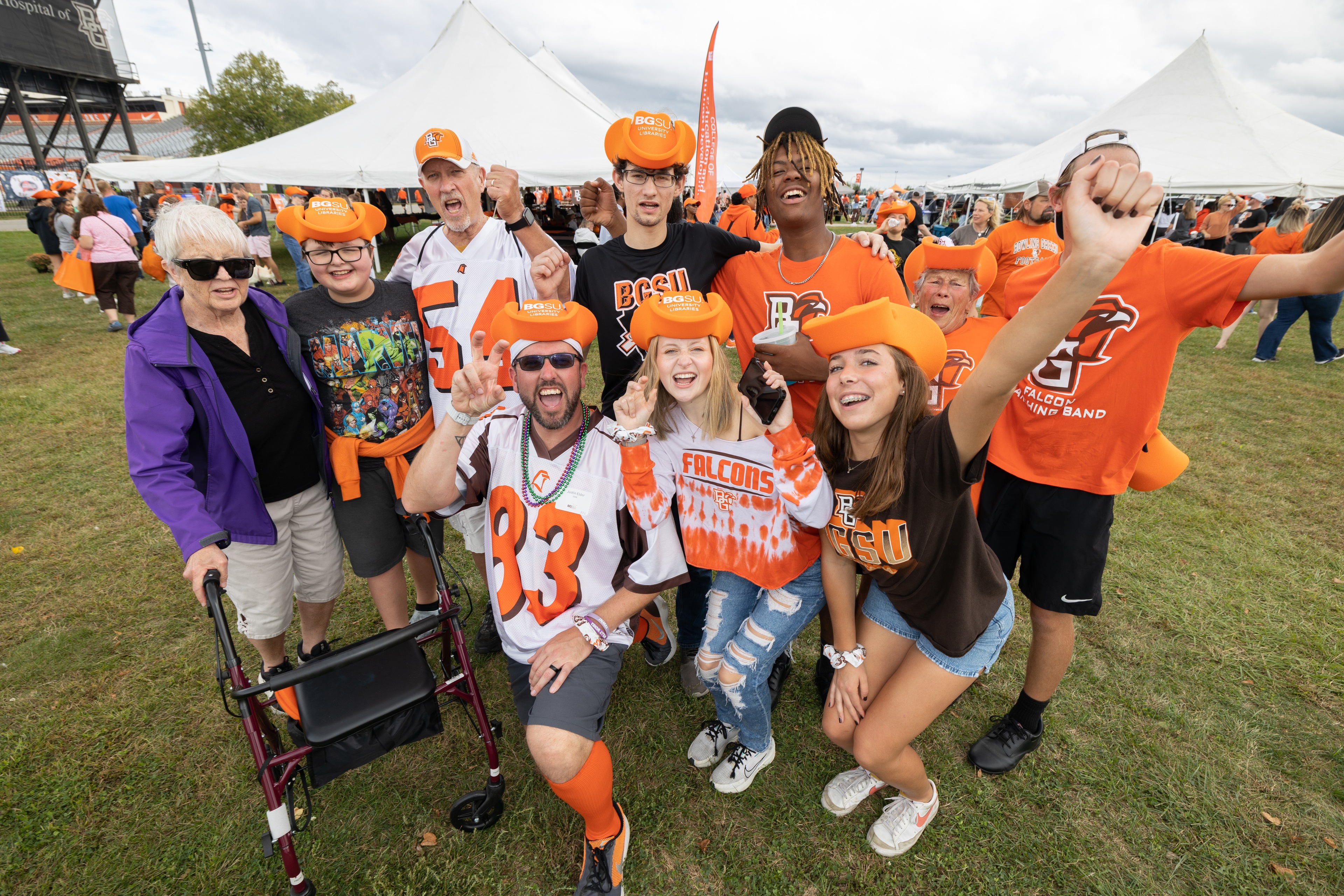 A group of people in BGSU gear posing for a photo