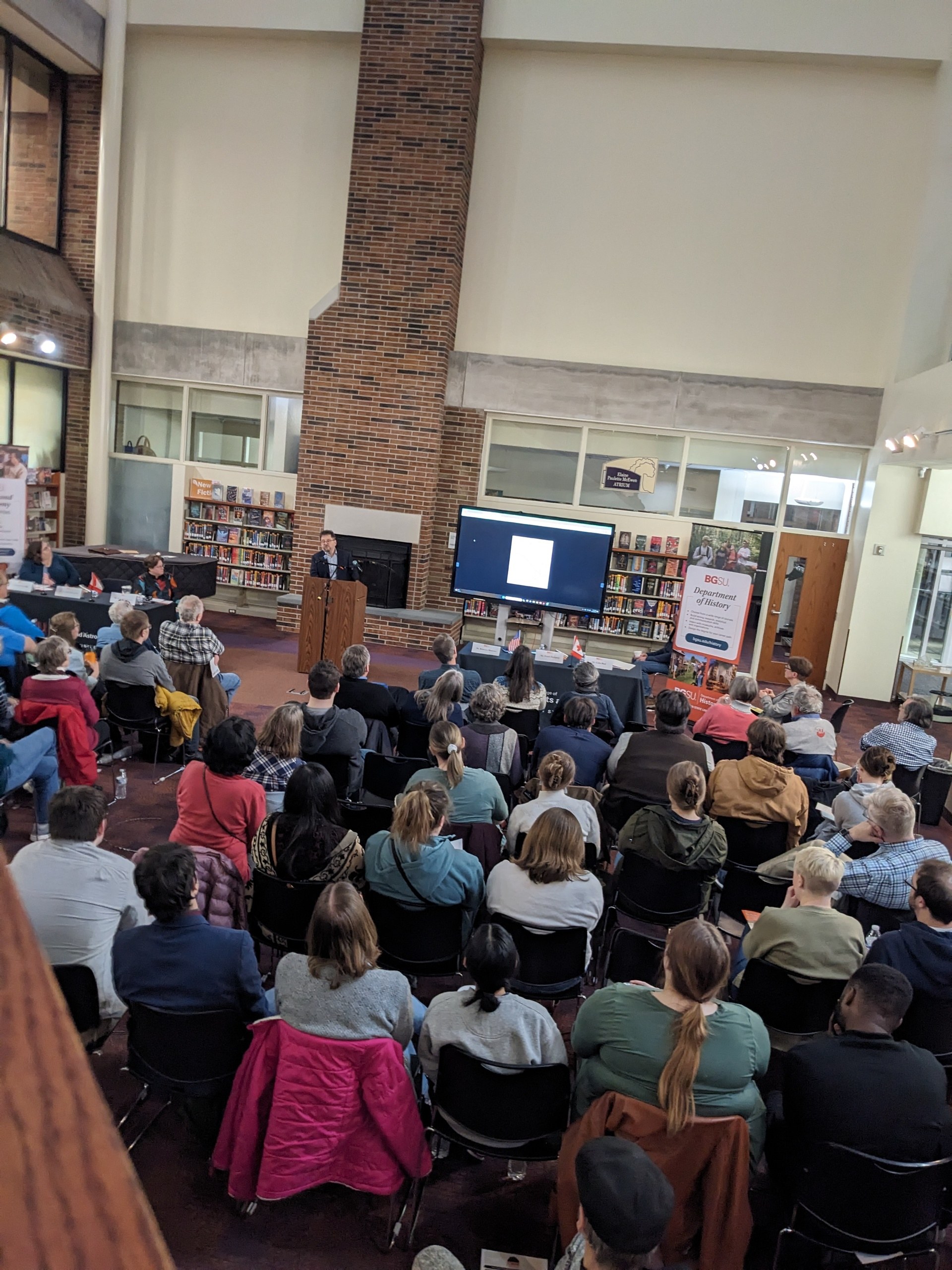 People sitting and looking at a speaker. 