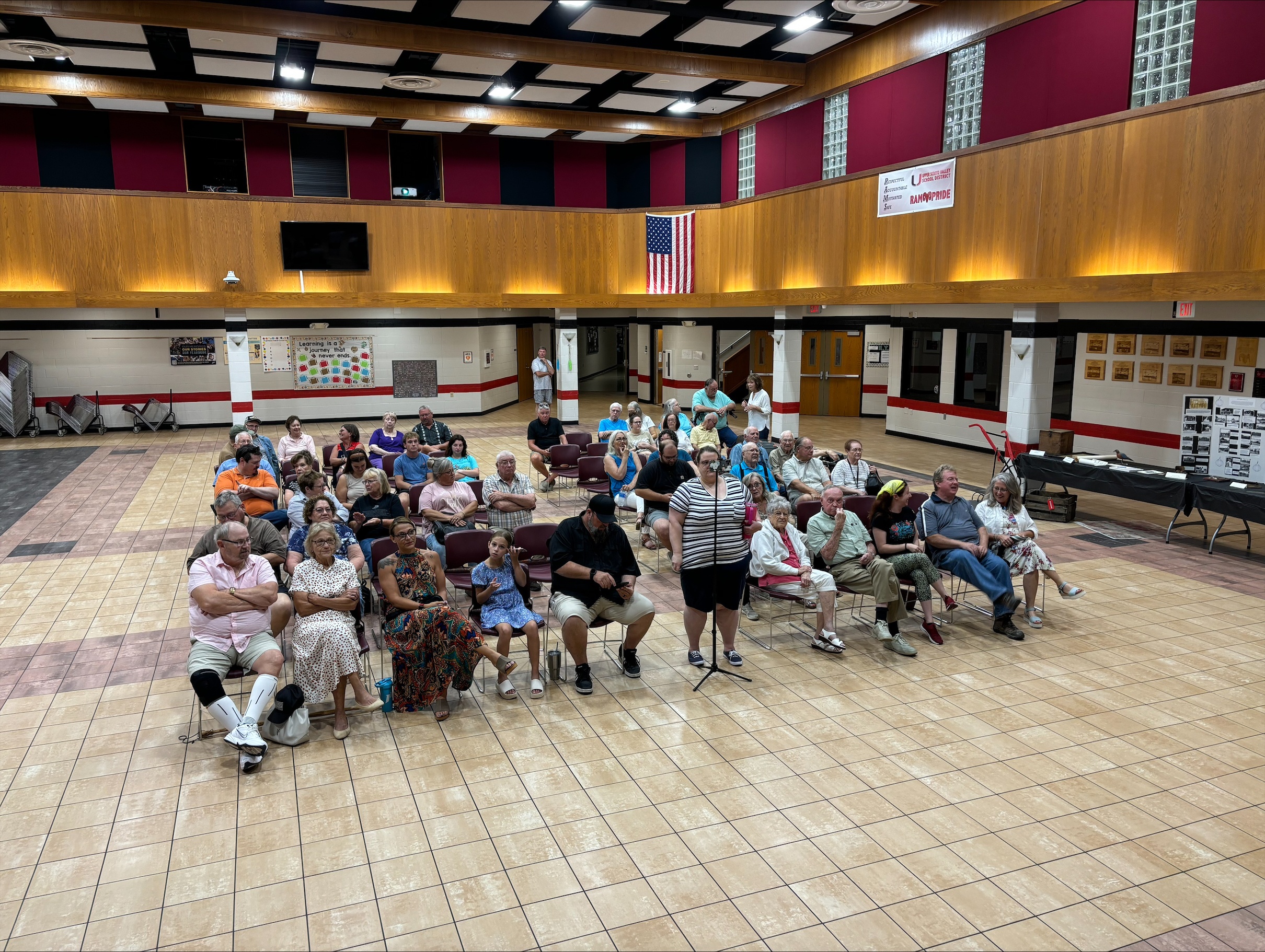 A group of people sitting in chairs and facing forward