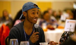 Keyonte’ (KJ) Ashford asking a question at the keynote performance of Ariana Brown