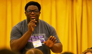 Kaden White asking a question at the keynote performance of Ariana Brown