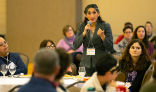 Dr. Alexandra Green asking a question at the keynote performance of Ariana Brown