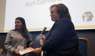 April Carmona receiving the Manny Vadillo Scholarship from Ana Brown, Interim Director, Office of Multicultural Affairs