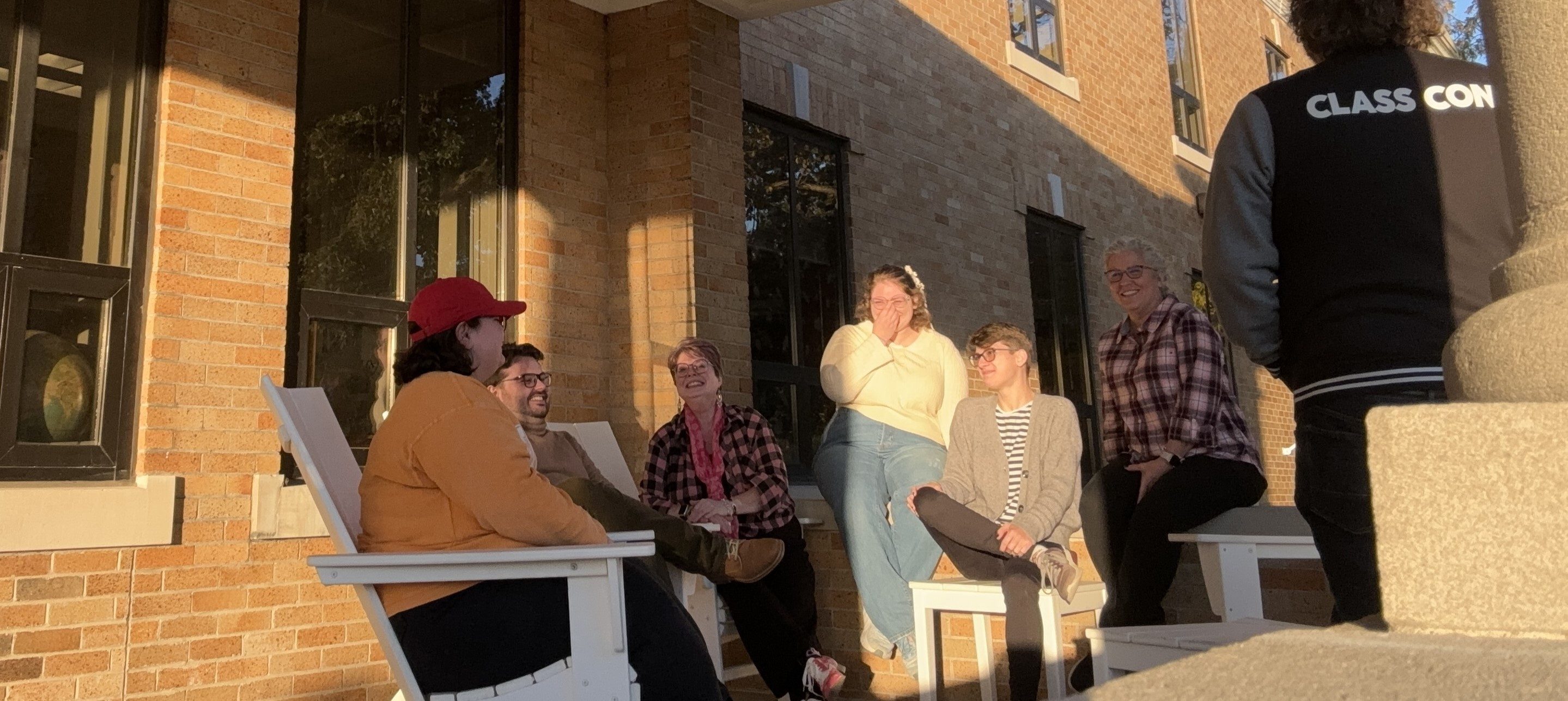 Ray Browne Association members gather on the porch of Shatzel Hall for their monthly meeting.