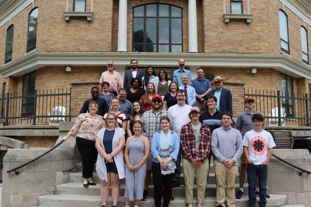 Graduate students and faculty posing in front of Williams Hall