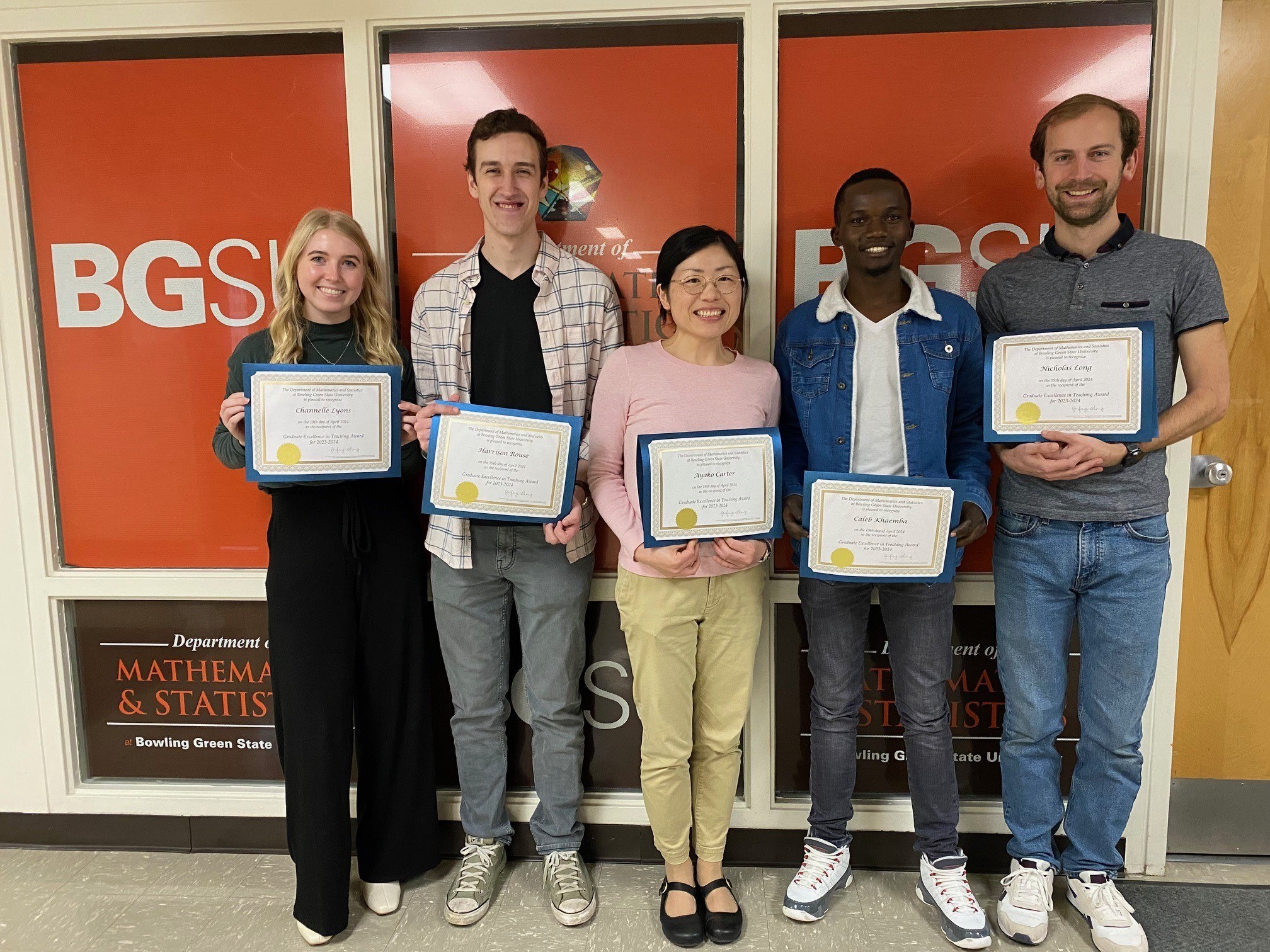 Group of people holding teaching awards 