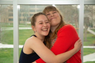 Junior Brionna Scebbi and graduating senior Holly Shively celebrate.