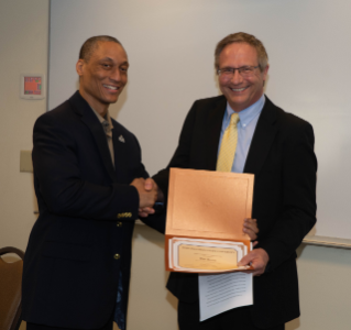 BGSU Journalism alum Jared Wadley presents Bob Bortel with his award as a KTA Journalism Hall of Fame inductee.