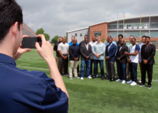 Players pose for a group picture on the BGSU football field at the conclusion of the boot camp.