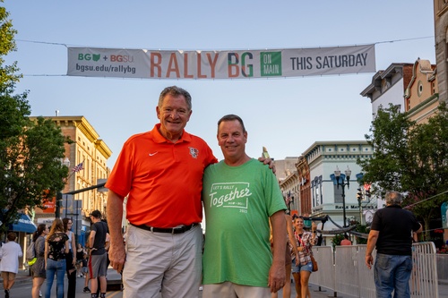 BGSU President Rodney K. Rogers and Mayor Mike Aspacher stand in front of Rally BG sign