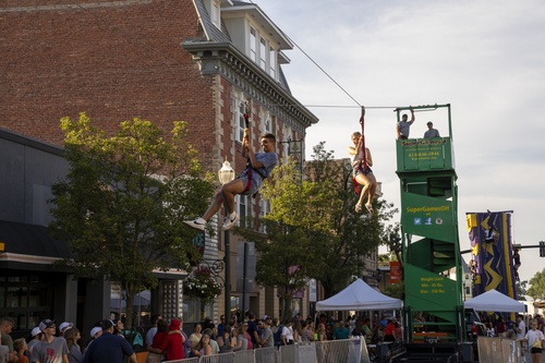 BG community members zipline down Main Street at Rally BG event
