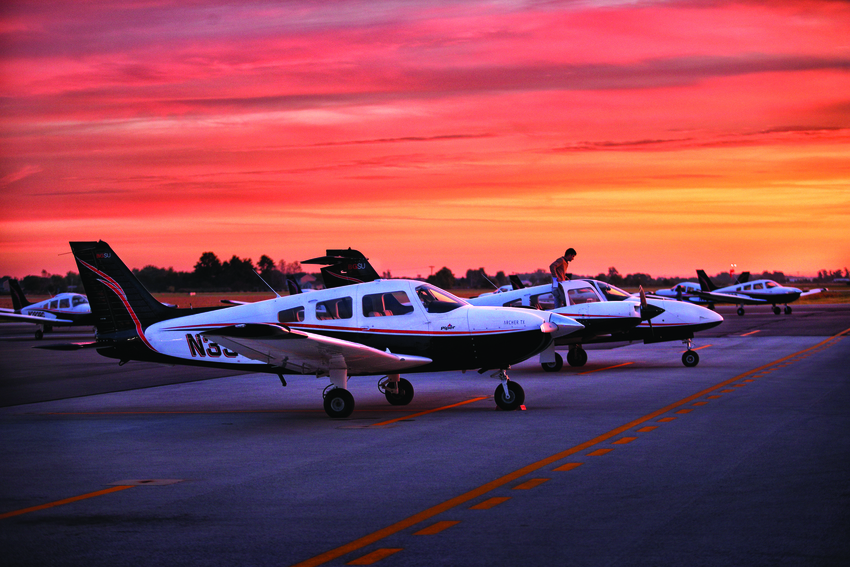 The BGSU fleet of planes with sunset behind