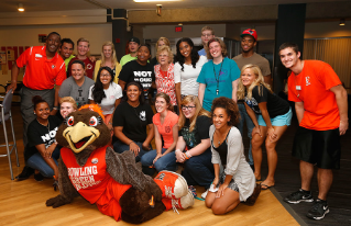 President Mary Ellen Mazey and Frieda Falcon join students during Falcon Fanfare.