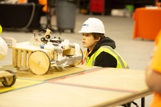 student focusing on robot project