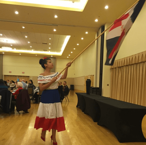 Woman in dress holding flag