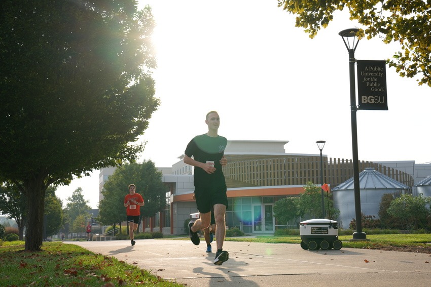 Runners pass Carillon Place during the Freddie & Frieda 5K on Saturday morning.