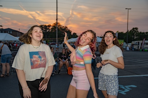 Three women dance at a block party