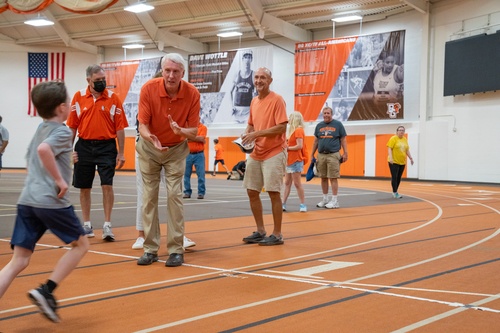 Olympian Dave Wottle cheers on a runner