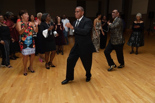 Two men dance in front of a crowd