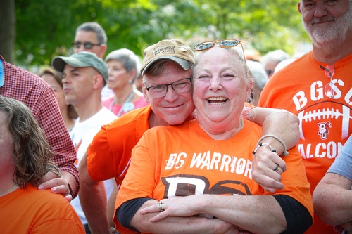 Two people smile and hug each other