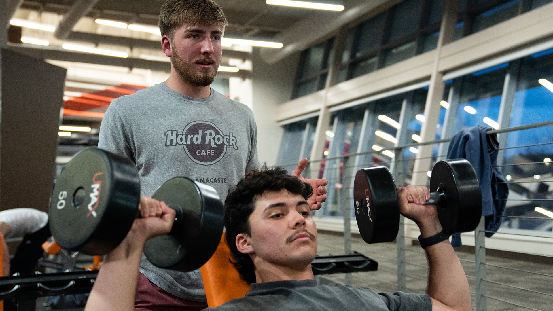 A person lifting weights at the BGSU Student Recreation Center.