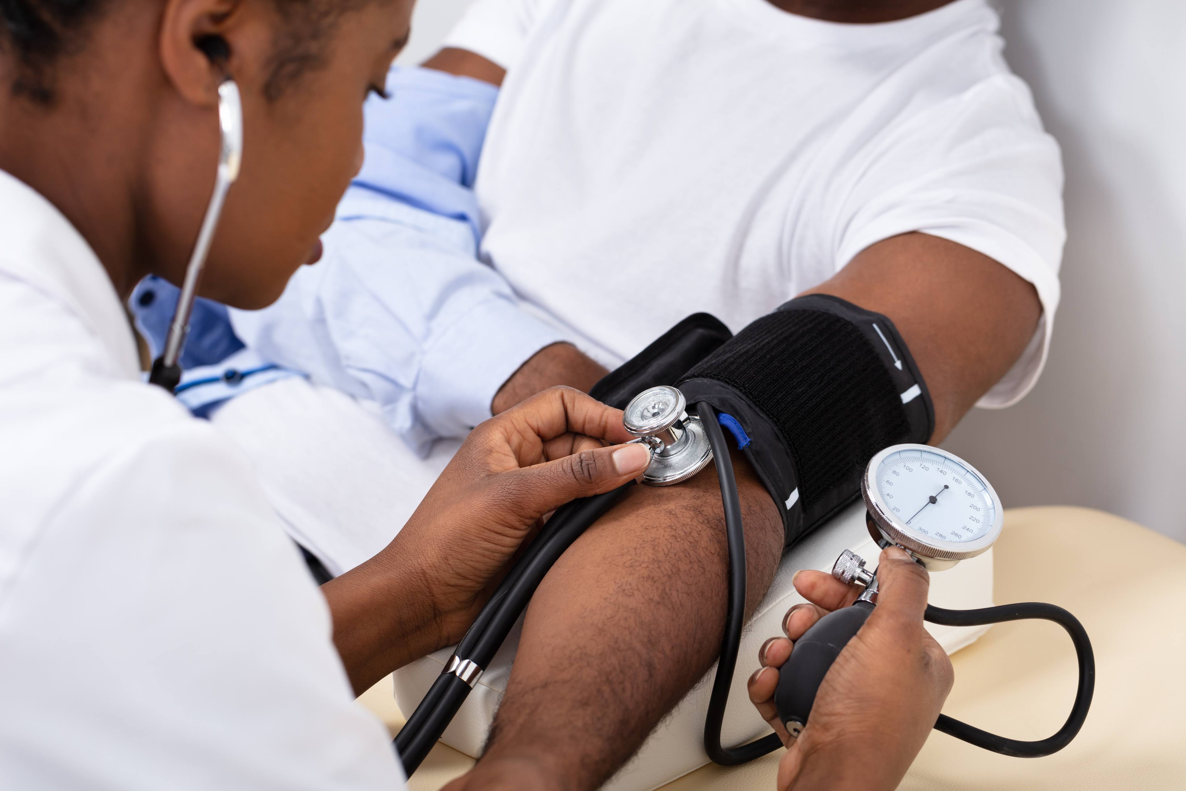 Doctor checks blood pressure of patient