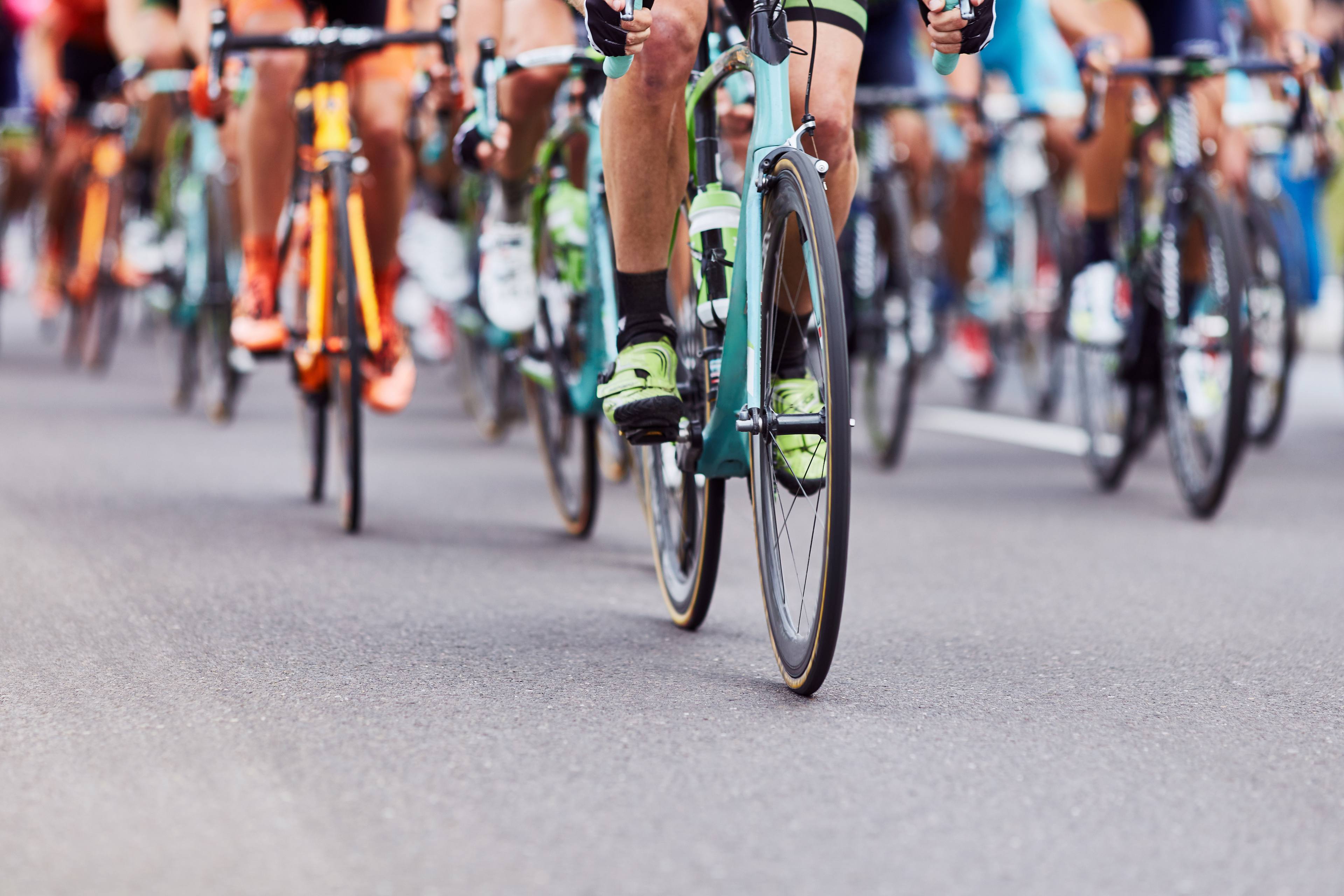 A group of cyclists riding on the road