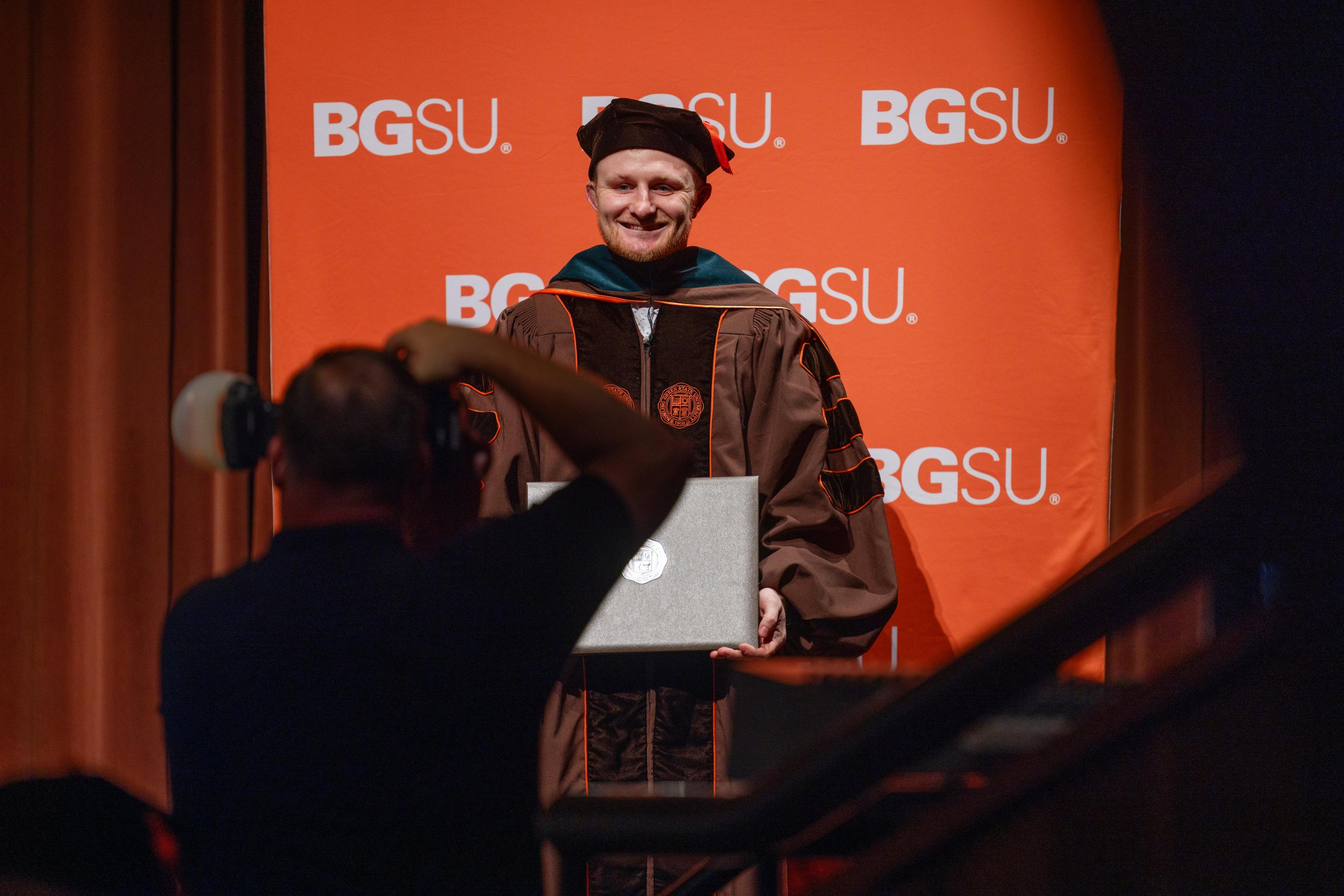 BGSU graduate Dr. James Waters receives his diploma at graduation.