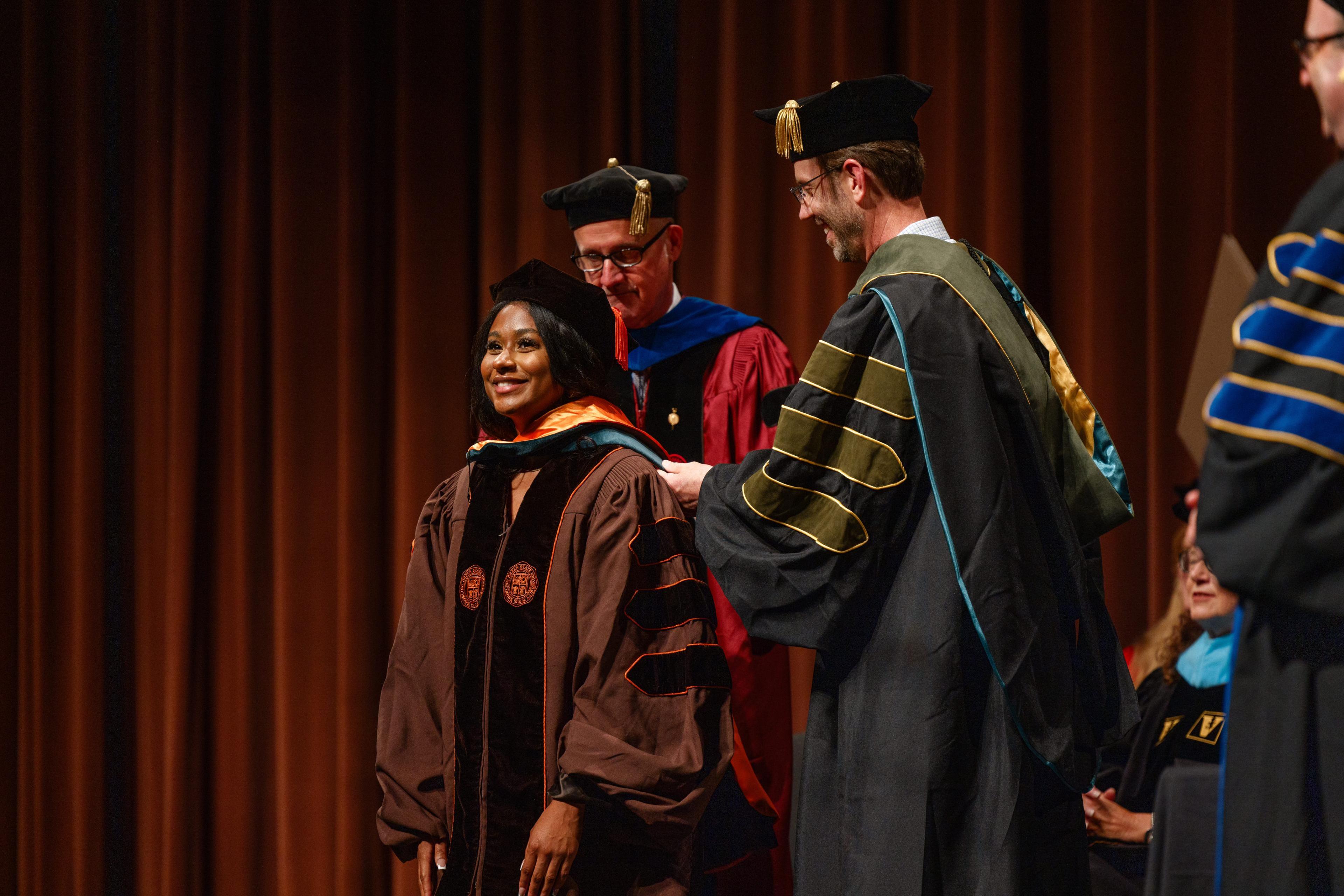 BGSU graduate Mekayla Abrahams is hooded during the DPT graduation ceremony.