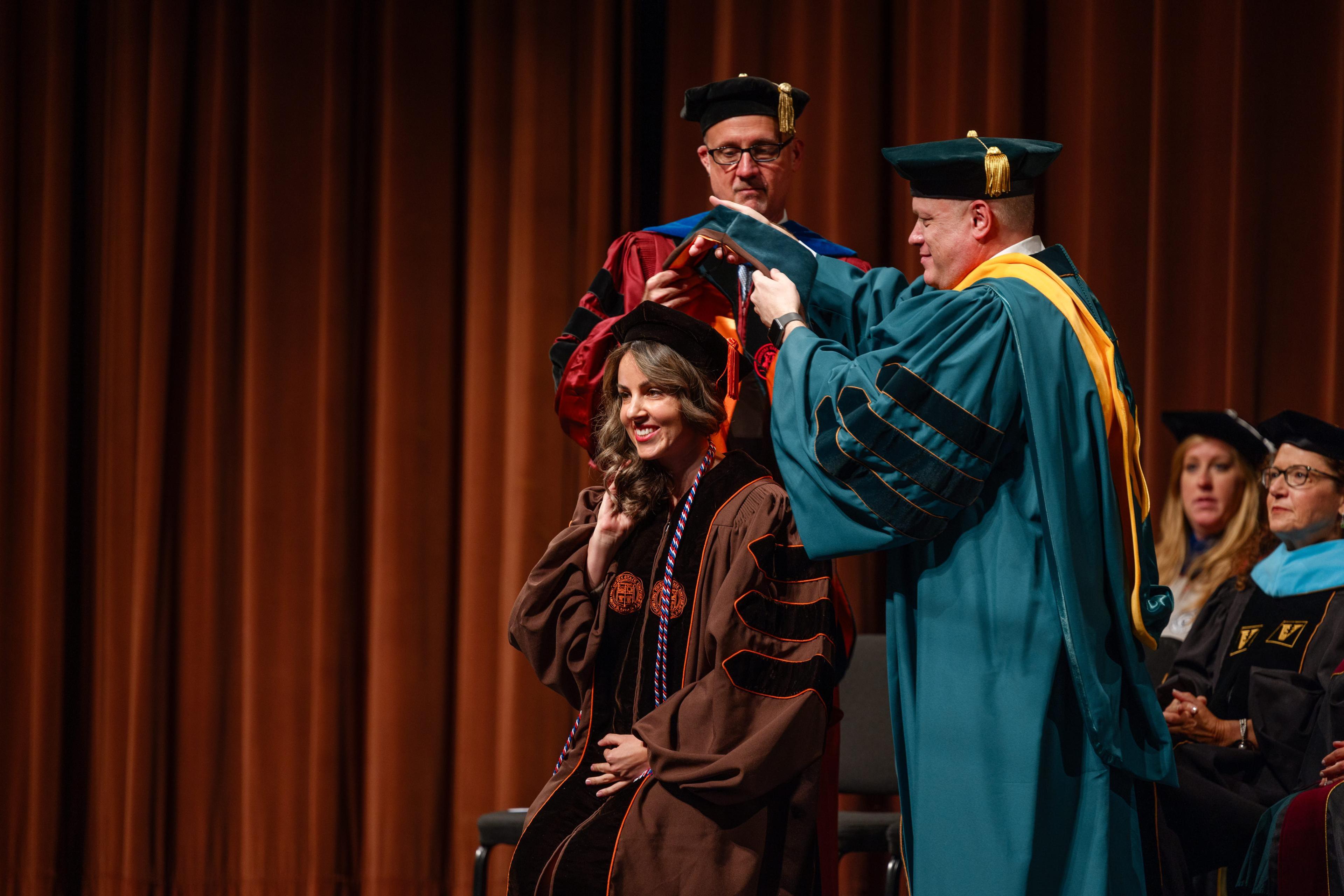 BGSU graduate Tedi Bunch is hooded during the DPT graduation ceremony.