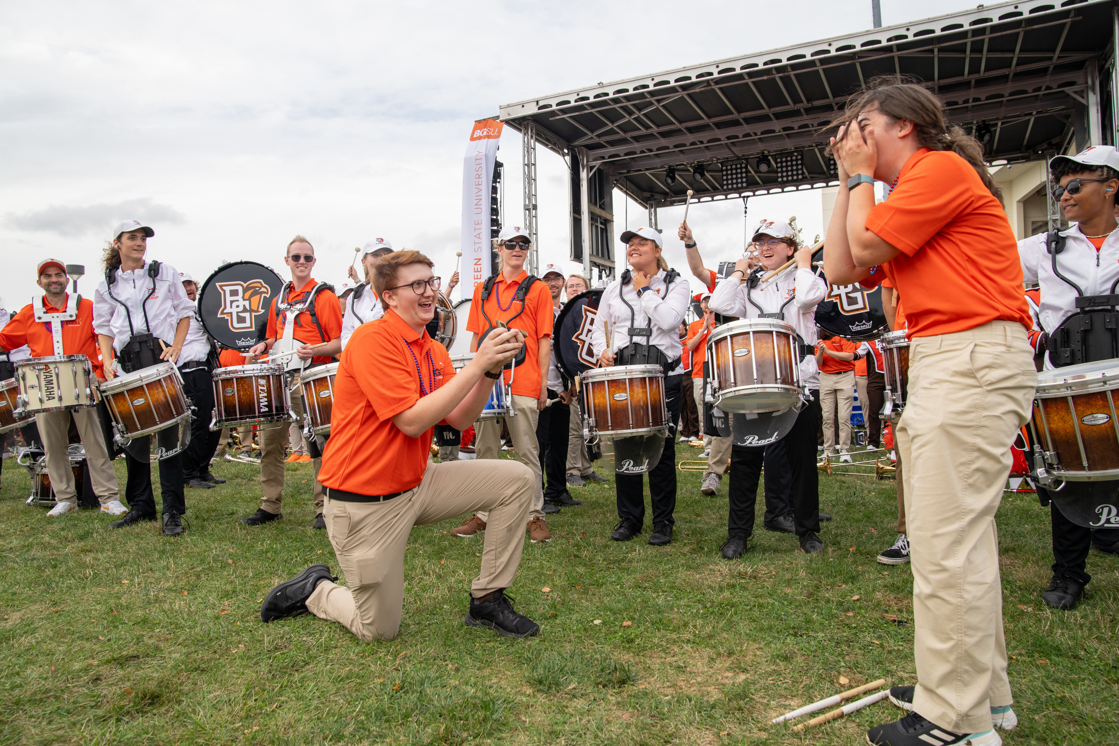 BGSU alumnus Mitchell Cash is on one knee while Ana Cunningham covers her face with her hands.