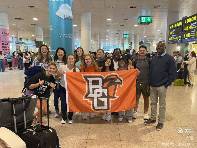 Students hold a BGSU flag.