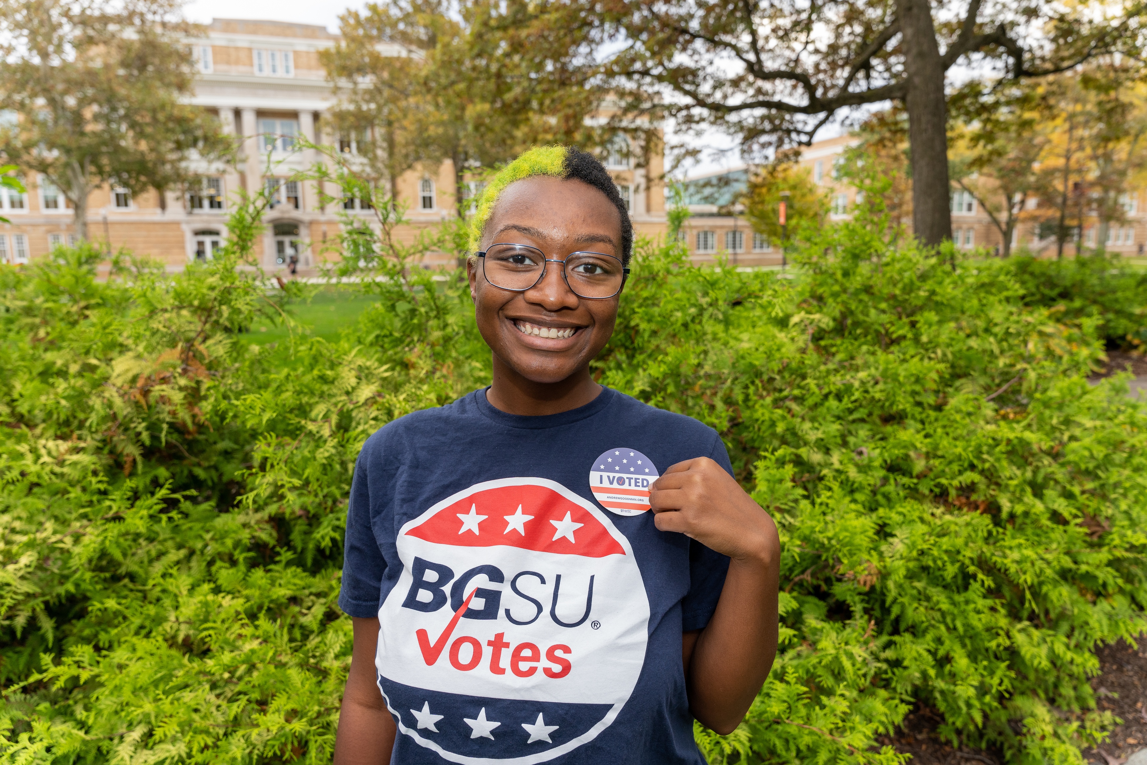 A BGSU student smiles while wearing a BGSU Votes shirt.