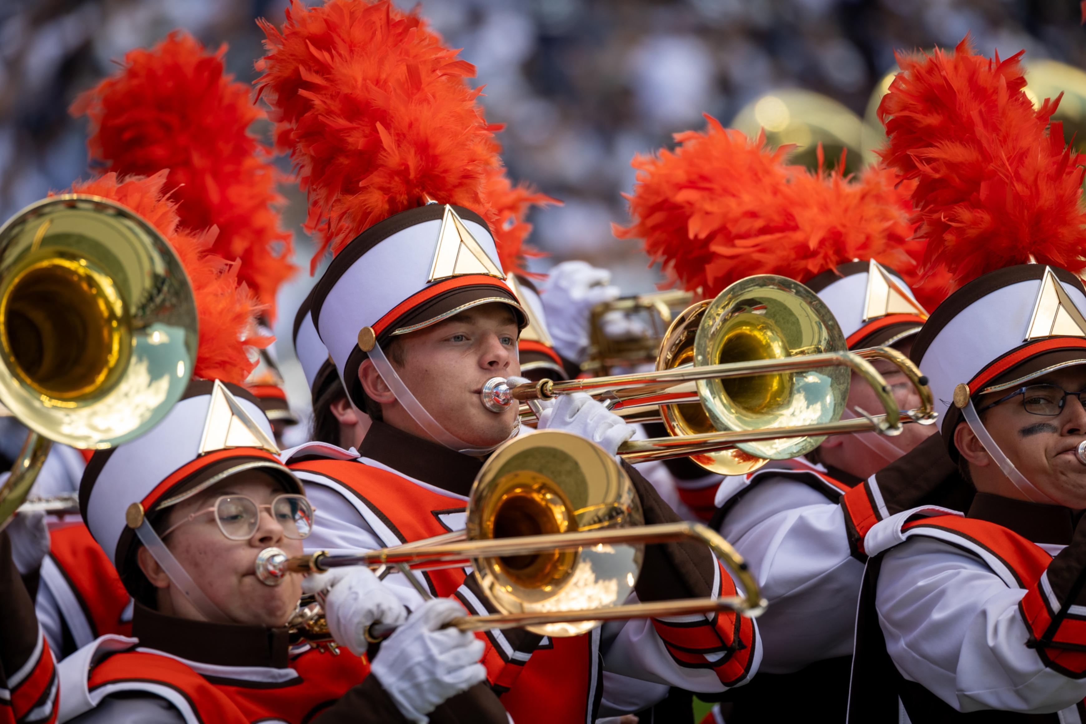 BGSU Falcon Marching Band members play the trombone during a performance.