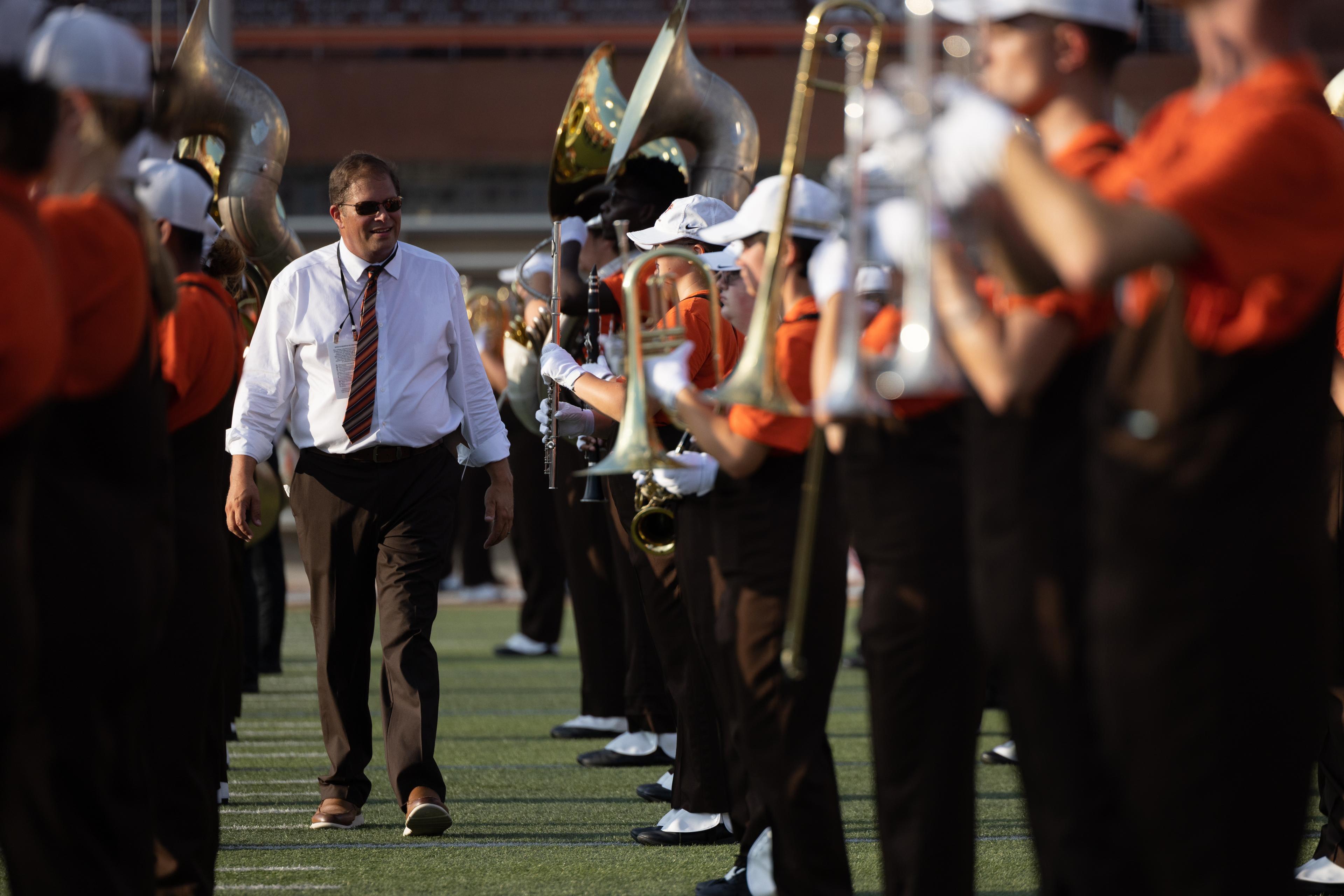 A Falcon Marching Band member plays a trumpet