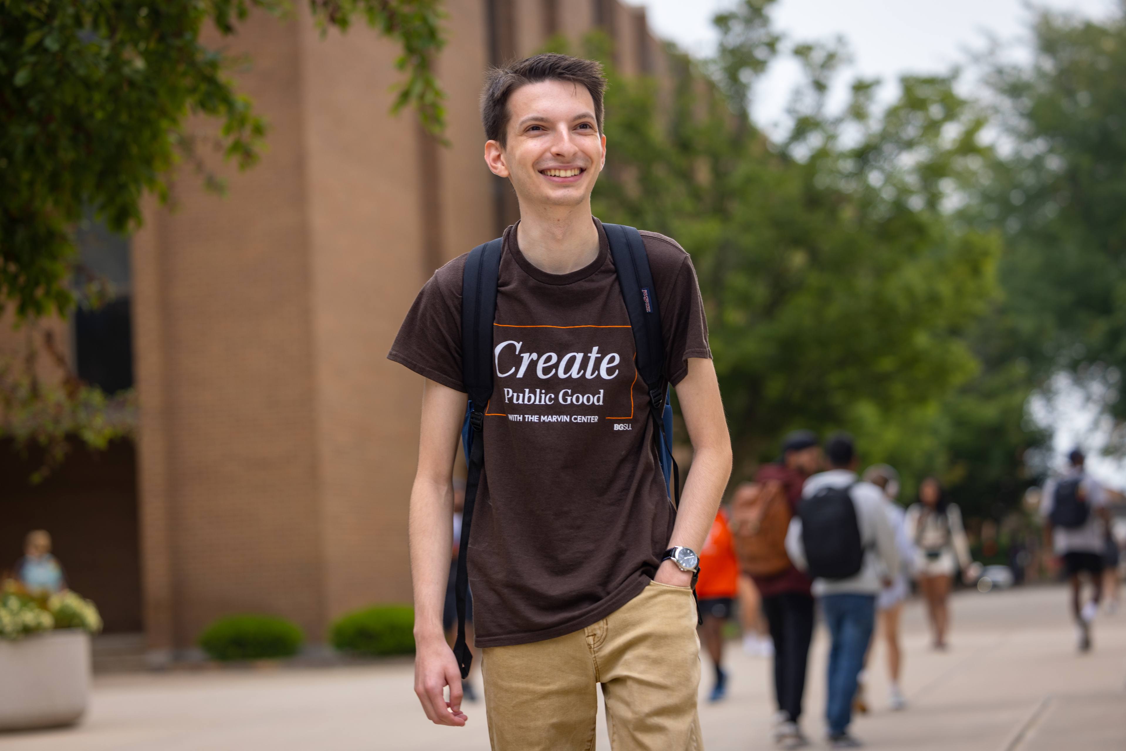 College student walks down sidewalk