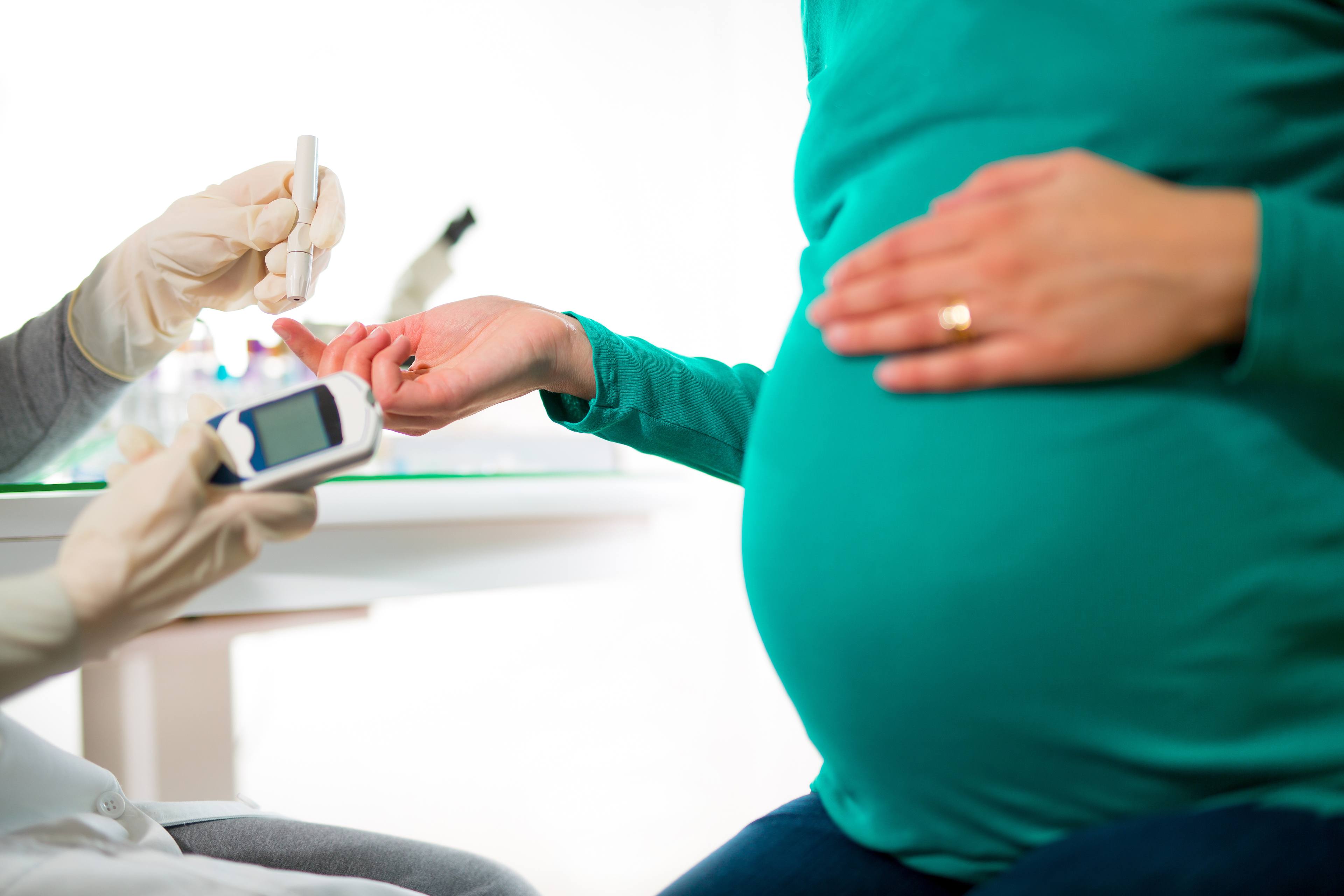 A pregnant woman takes a glucose test.