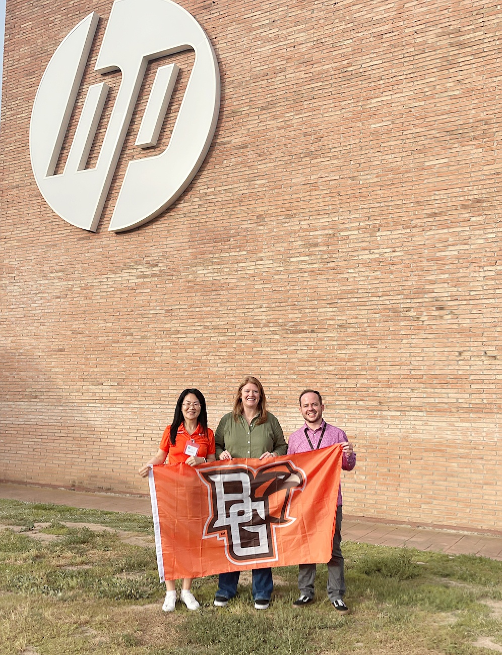 Three people pose for a photo.