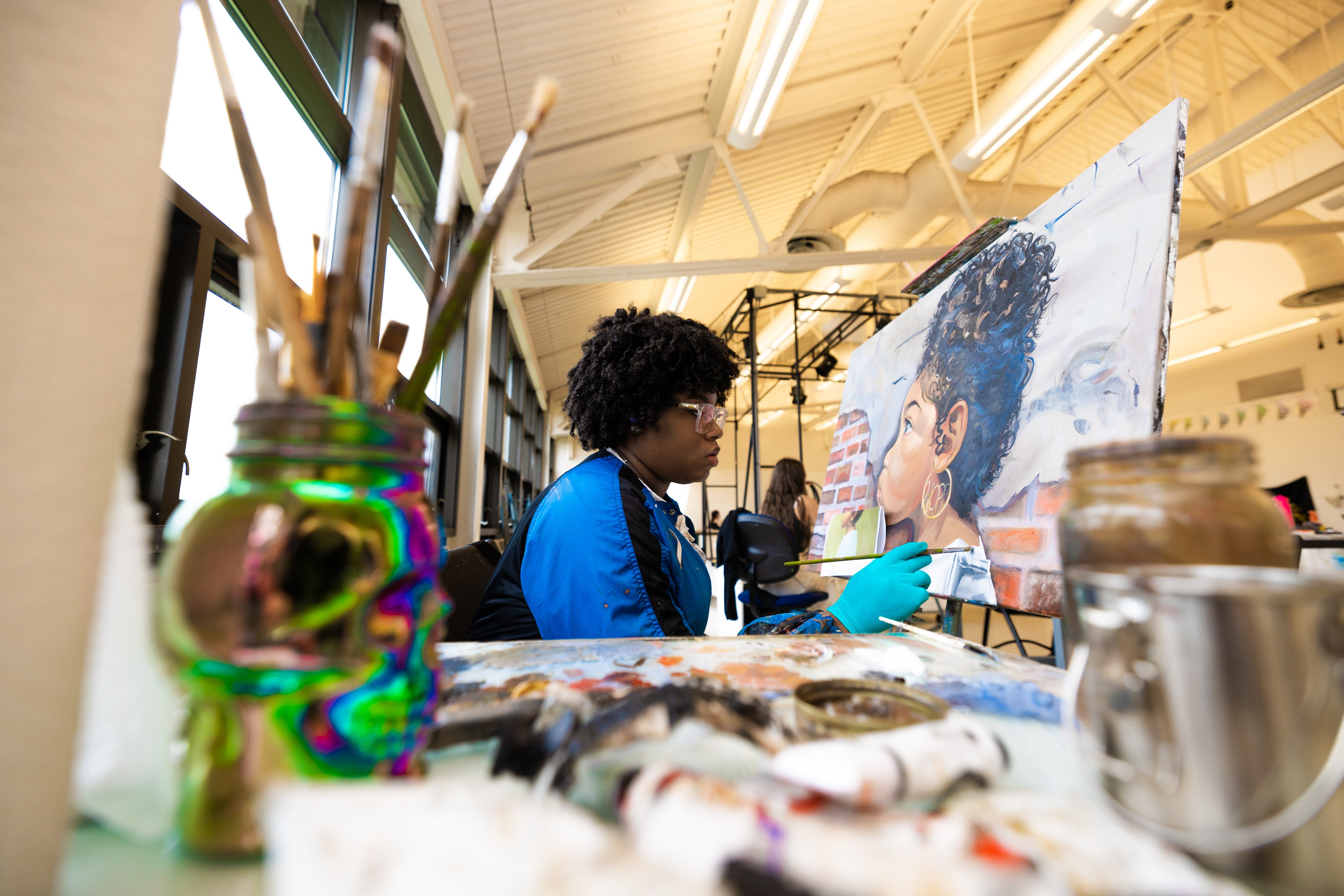 A BGSU School of Art student paints in class.