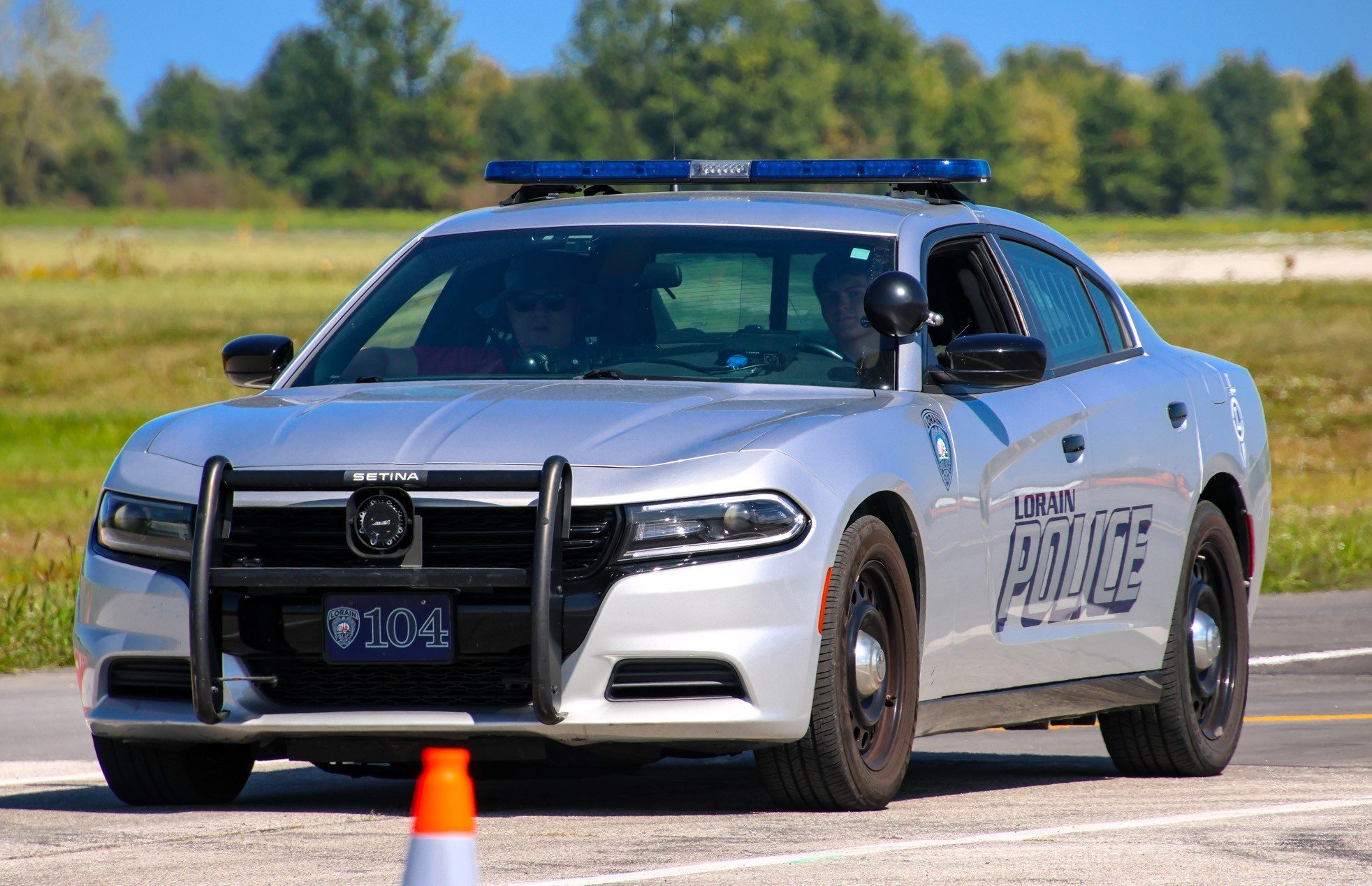 A student drives a police car.