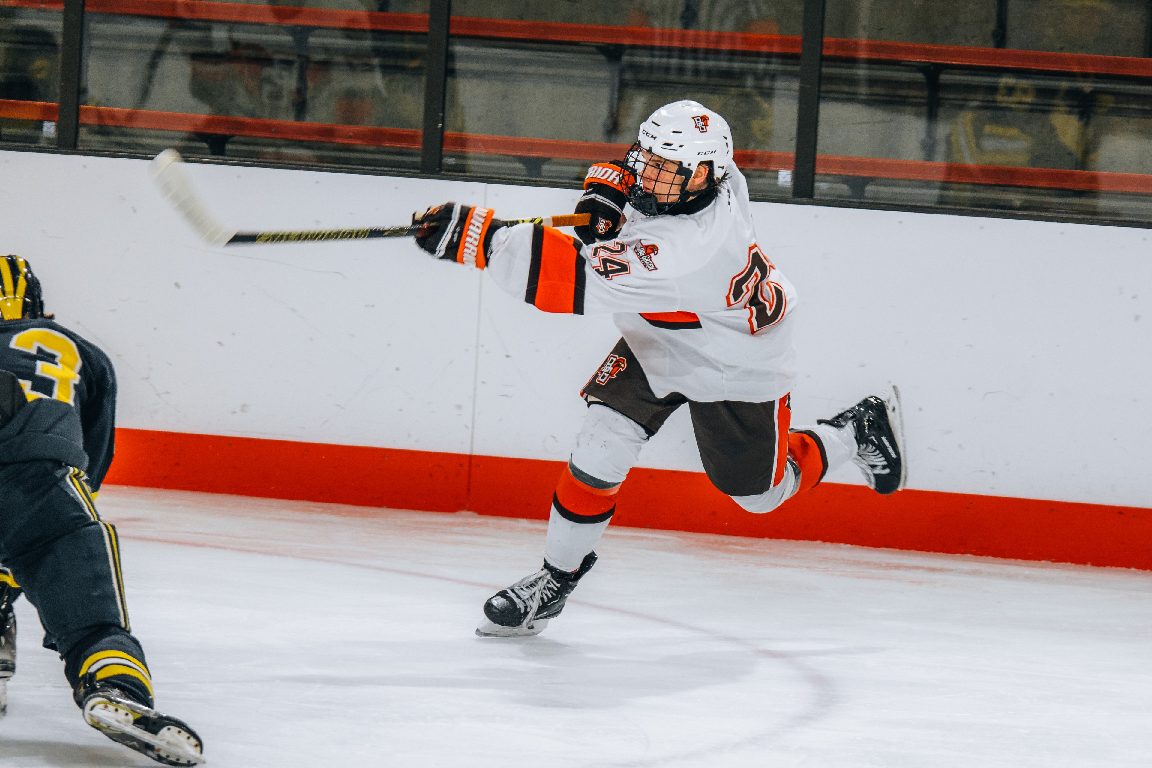 A hockey player takes a shot.