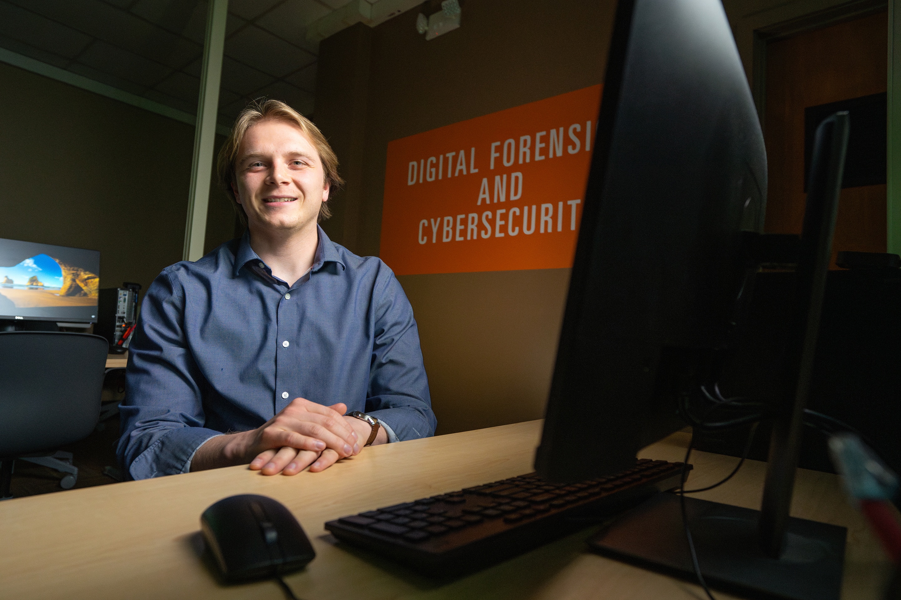  A man poses for a picture in a computer lab