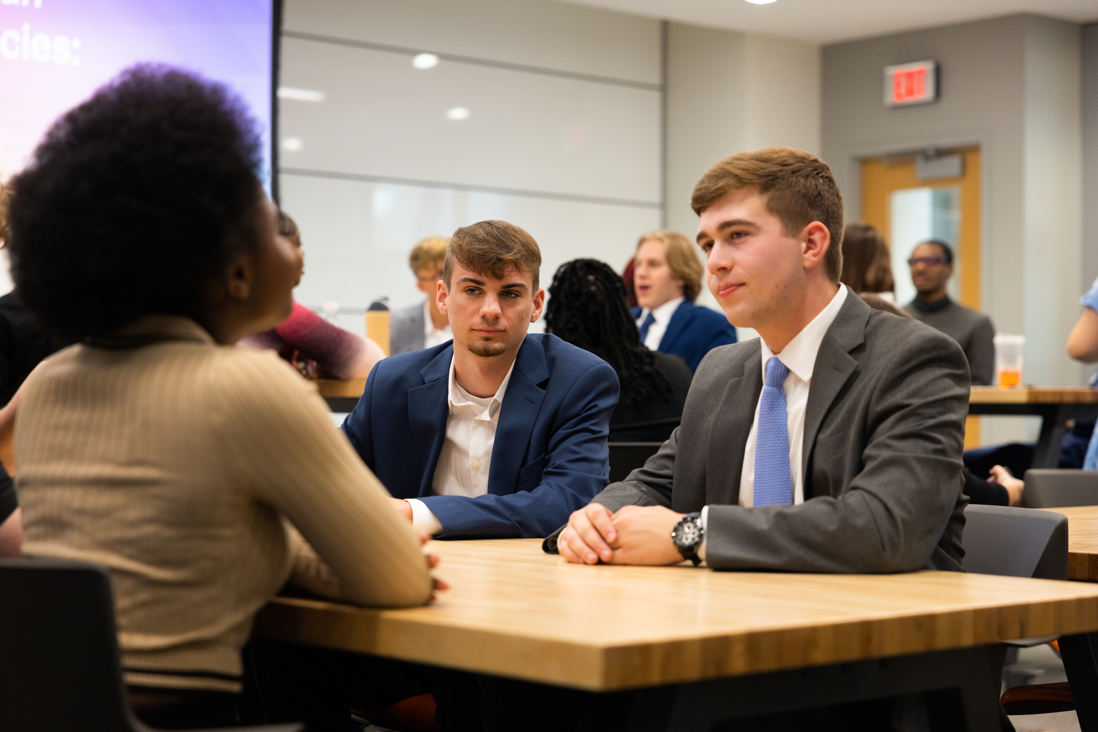 BGSU students talk at a table.