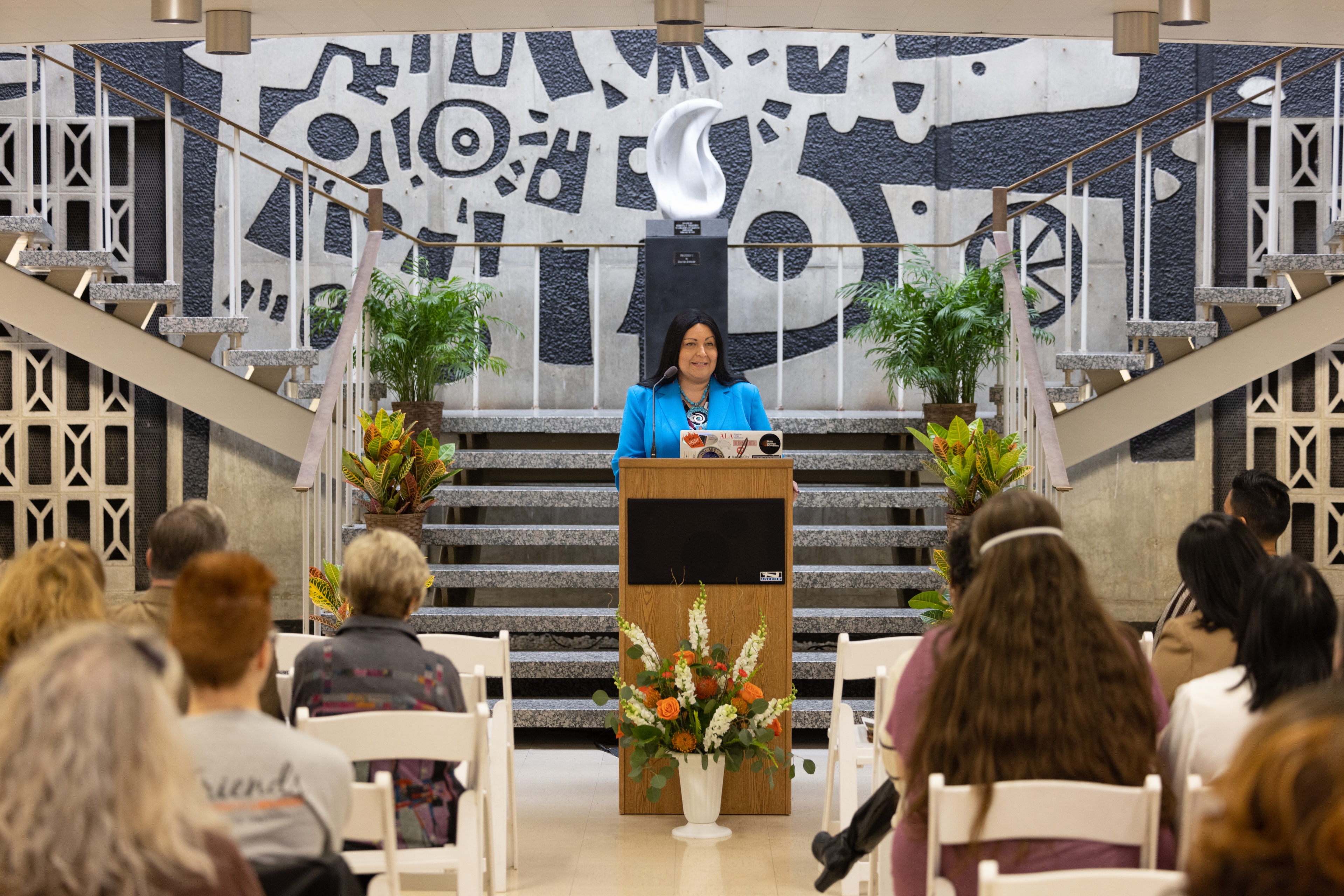 A person stands at a podium giving a speech