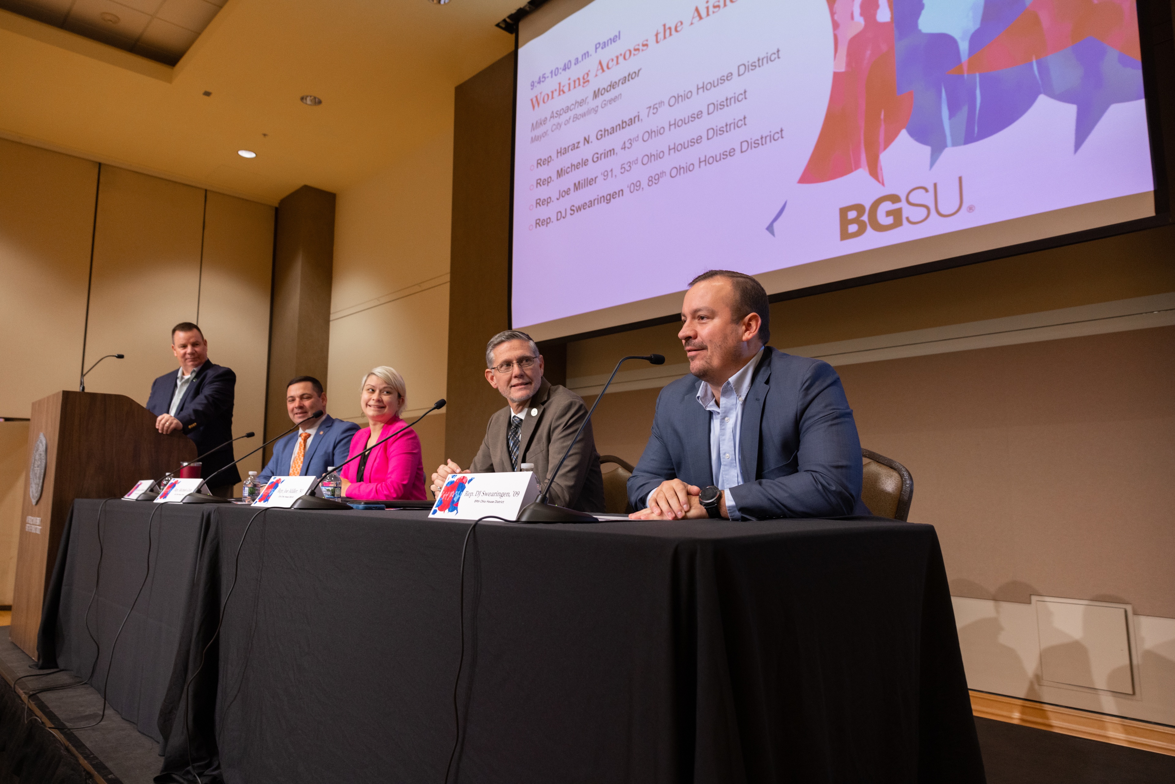 A group of elected officials sit at a table on stage during BGSU Day of Dialogue.