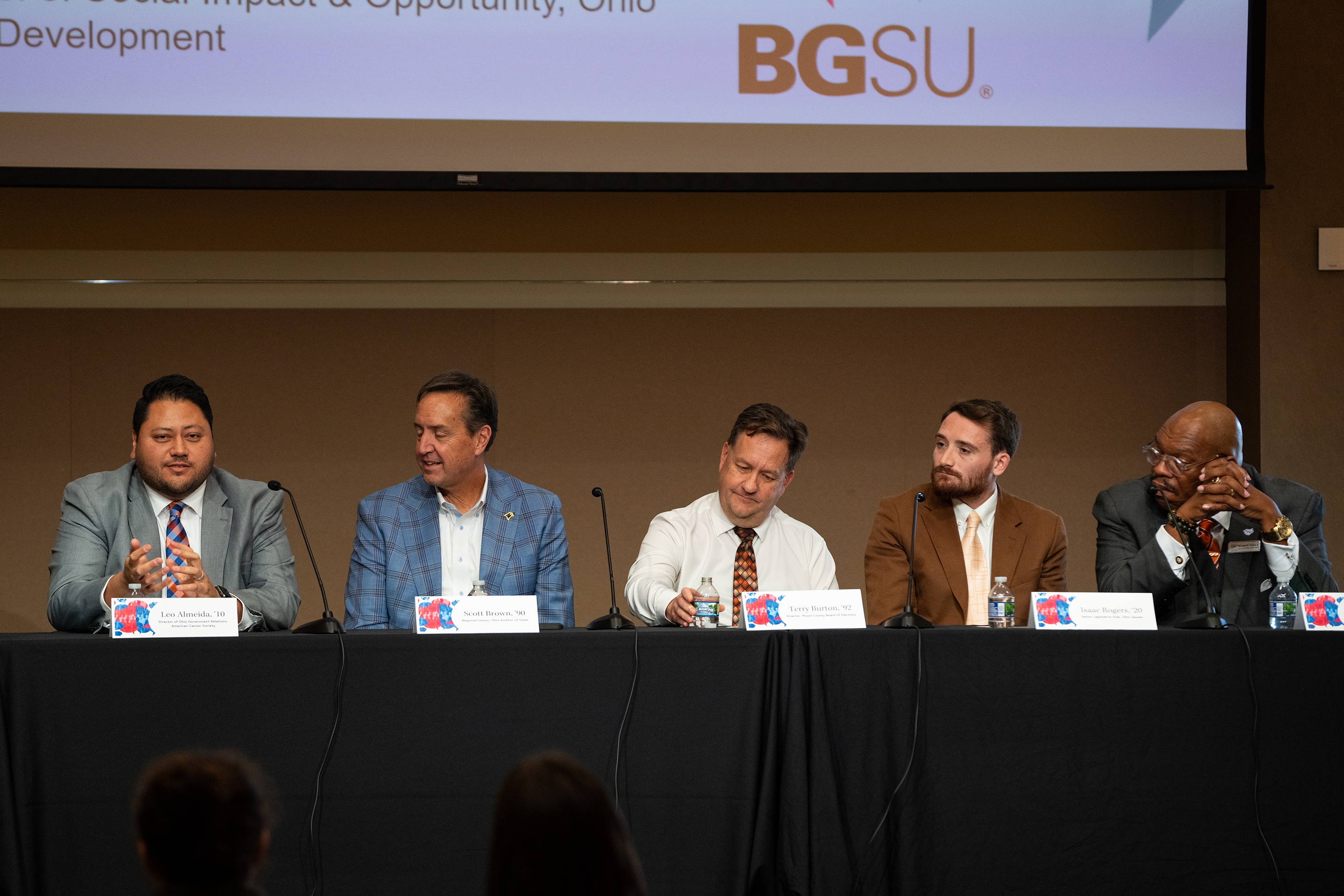 5 people sitting lined up at a table