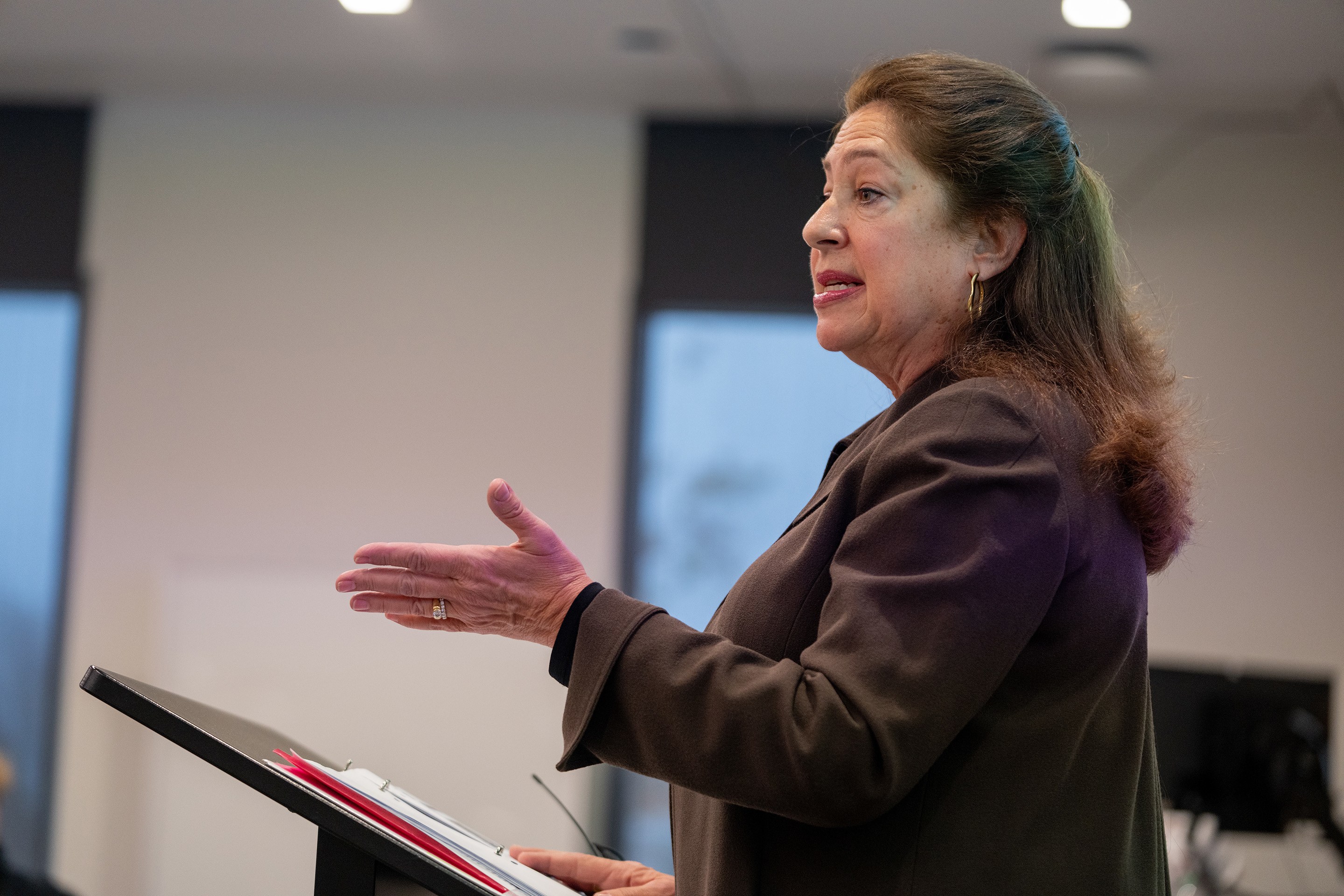 A woman speaks at a podium